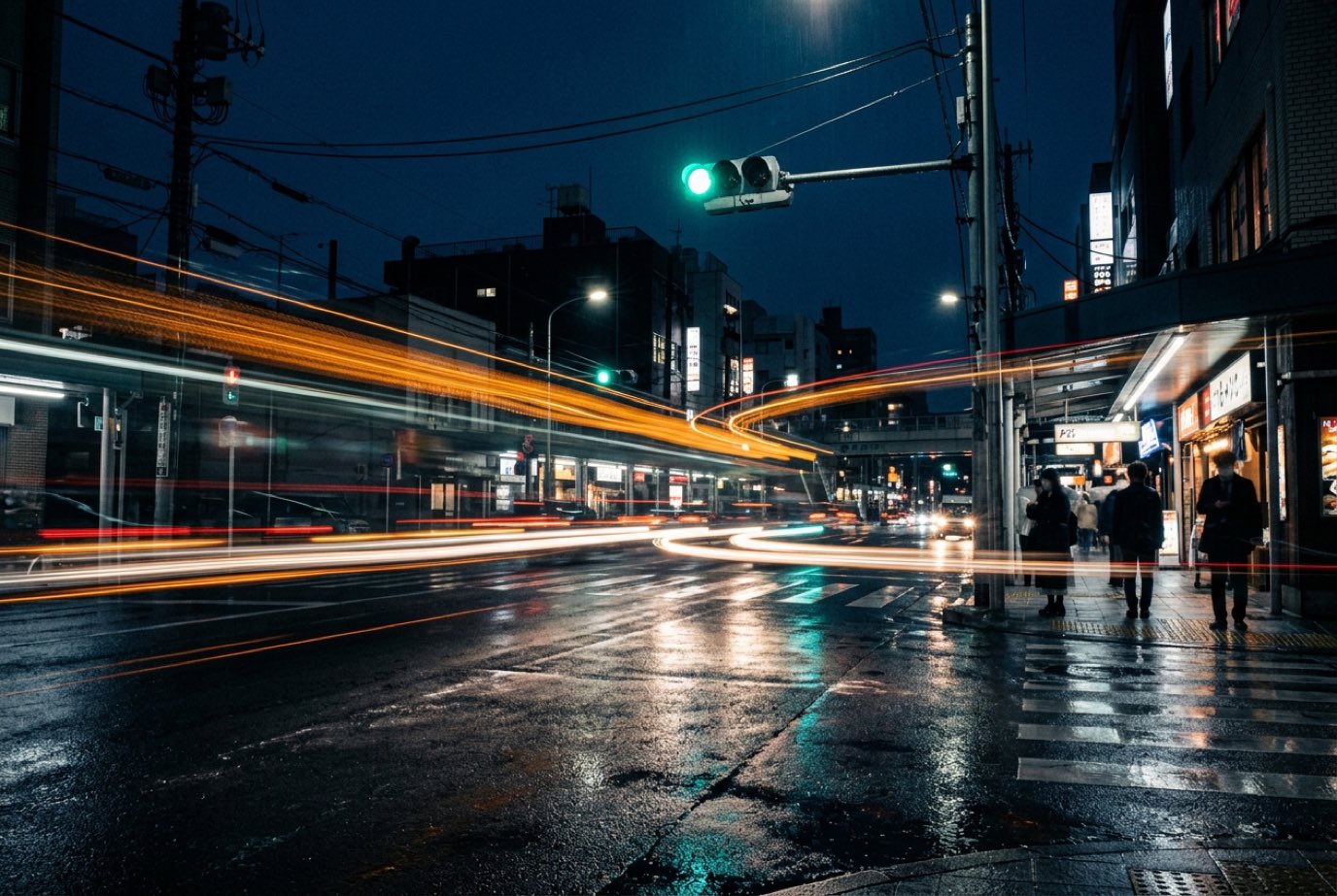 Illustrative concept image: long-exposure night traffic moving through a signalized intersection (not the project site)